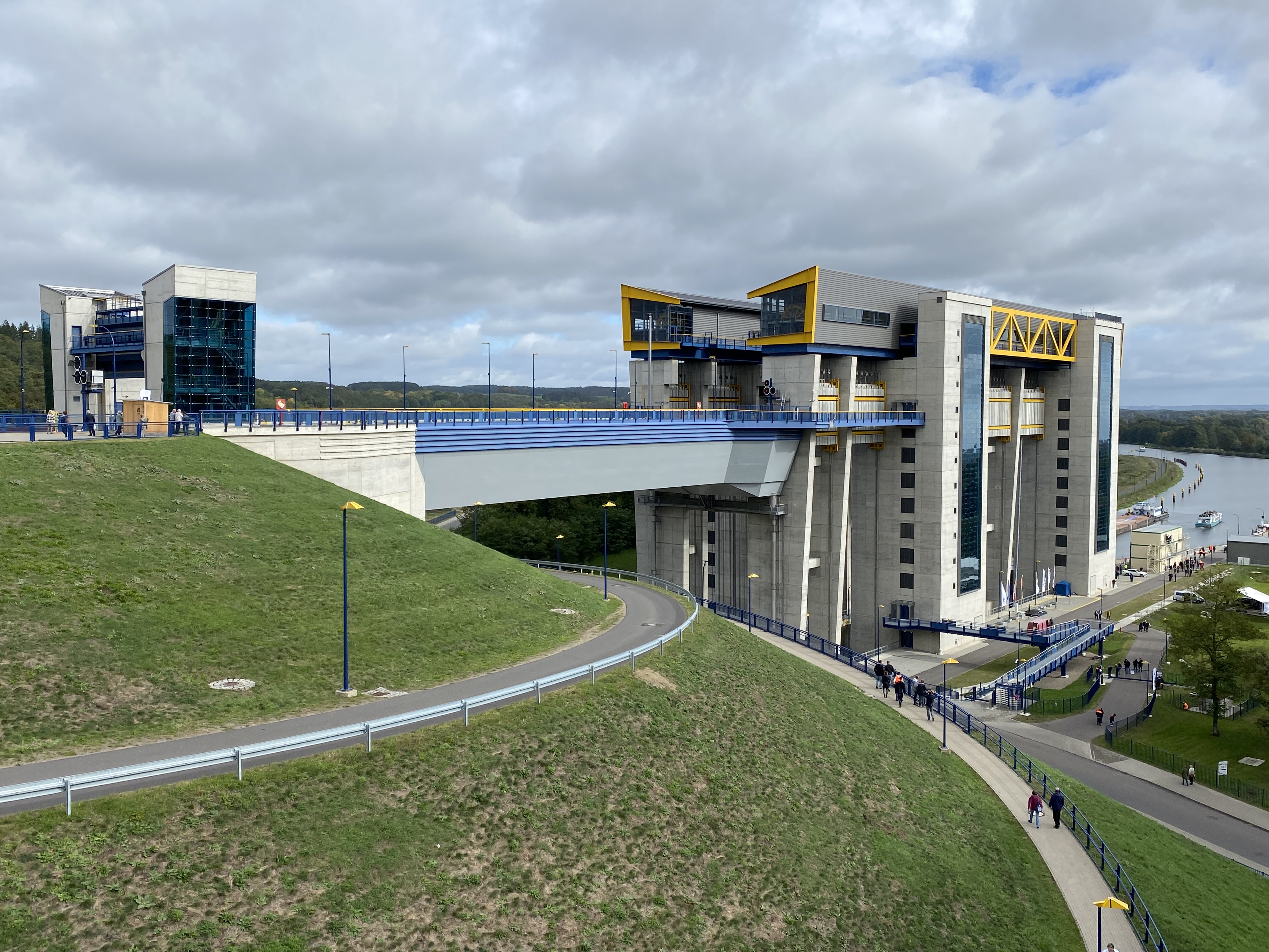 Elevated side view of the new Niederfinow ship lift with its access bridge, grass-covered embankments and the adjoining canal.